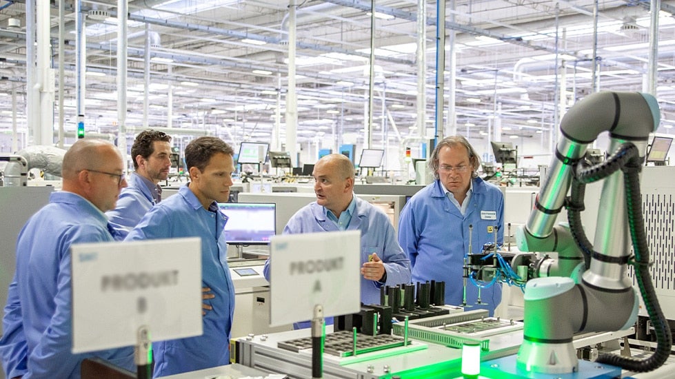 a group of manufacturing factory professionals collaborating on a project